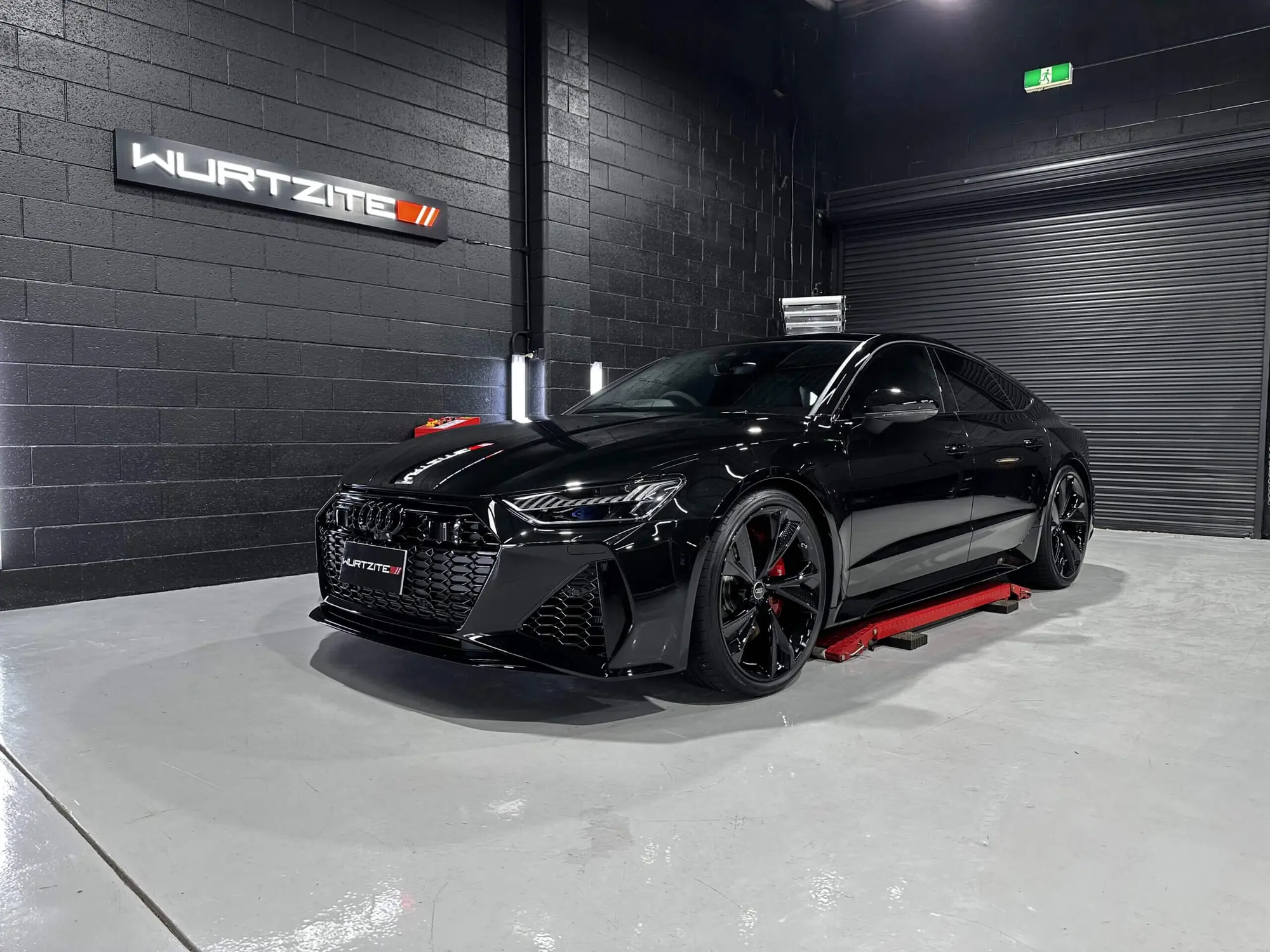 Black BMW coupe under the Wurtzite sign in the Ceramicar workshop at Windsor Gardens
