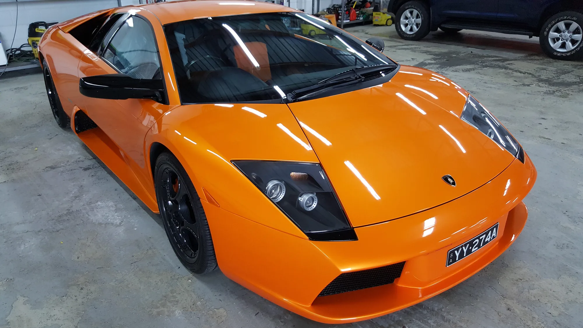 Orange Lamborghini Murcielago parked inside the Ceramicar workshop in Adelaide