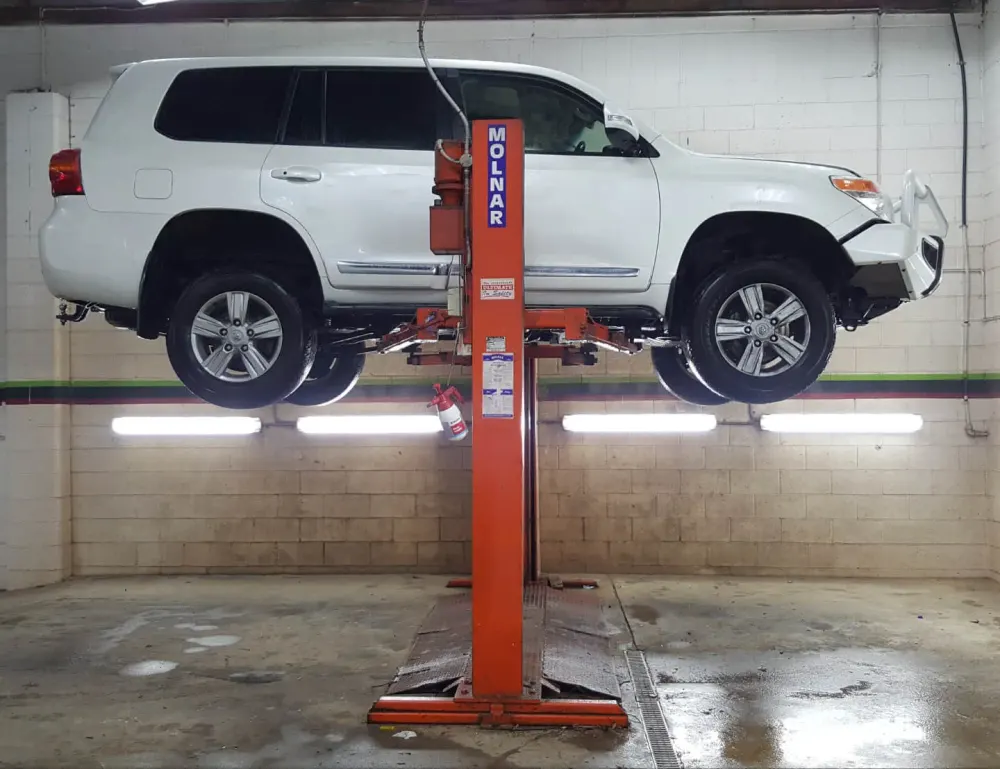 LandCruiser underbody steam cleaned on a hoist in the Ceramicar EPA approved wet bay