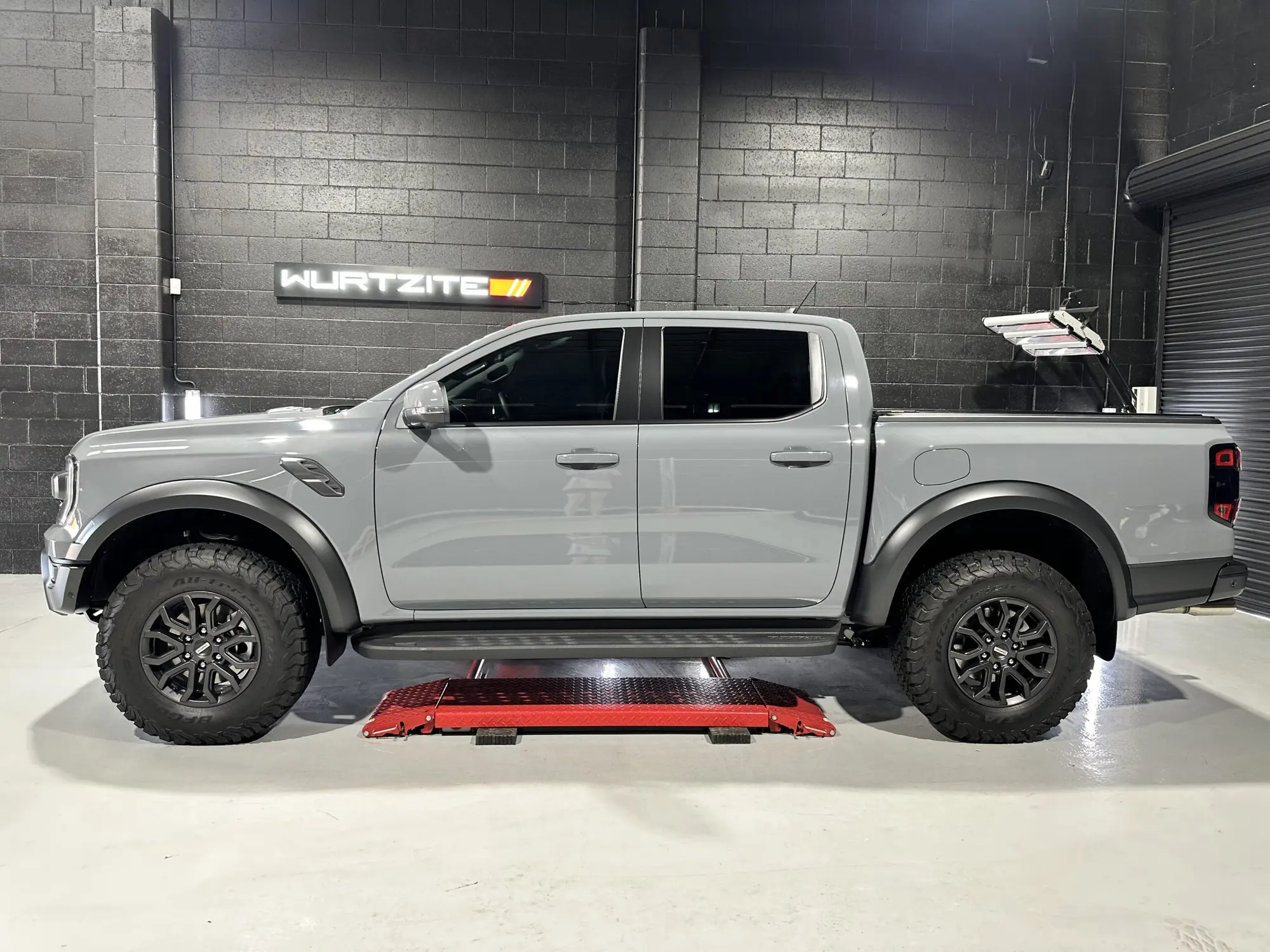 Grey Ford Ranger Raptor with tinted side glass in the Ceramicar Windsor Gardens workshop