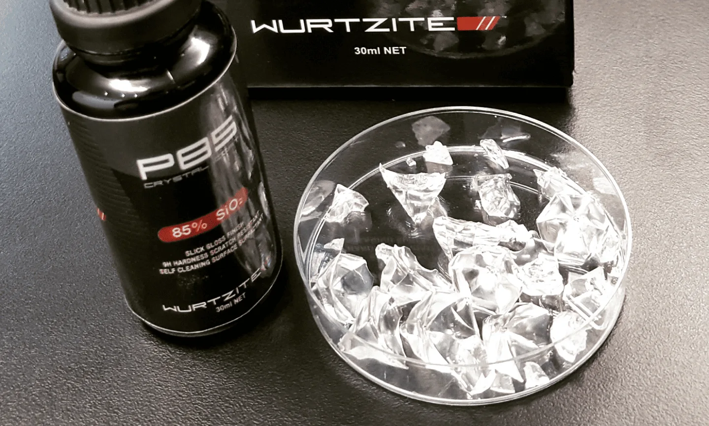 Wurtzite P85 50ml bottle beside a dish of the cured crystal coating it forms on paint